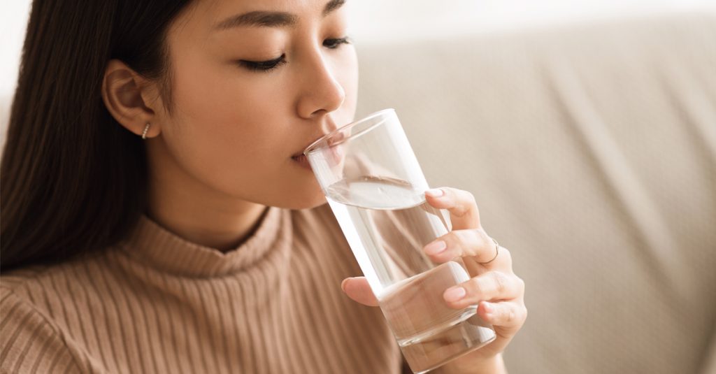 Woman drinking tap water